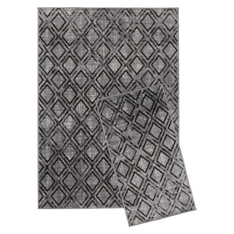 Harmaa, mustin salmiakkiruuduin kuvioitu Zoe-keskilattia ja pieni käytävämatto.